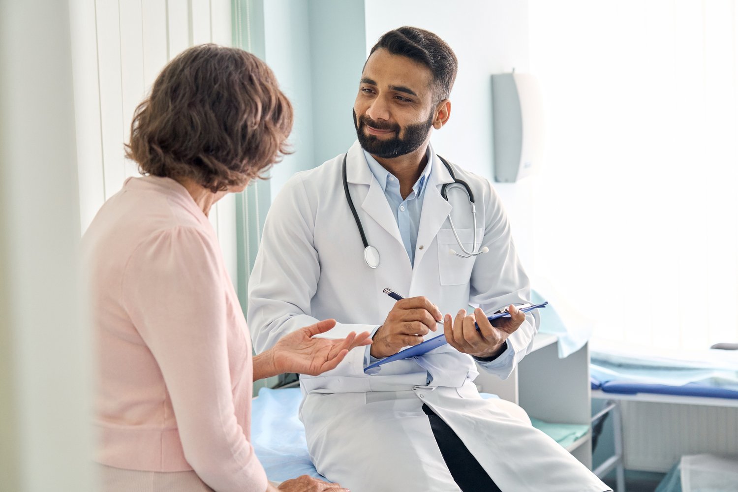 Physician speaking to a patient Physician speaking to a patient